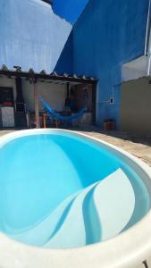 a large blue swimming pool in a building at Maré Alta Hostel in Ubatuba