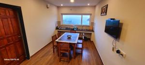 a small kitchen with a table and a window at Sky High Villa Annex in Kodaikānāl