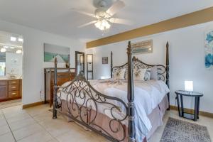 a bedroom with a bed and a ceiling fan at Pensacola Beach Condo with Patio and Access to Beach! in Pensacola Beach