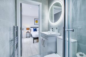 a bathroom with a sink and a mirror at Hybrid Resi - Uxbridge in Uxbridge