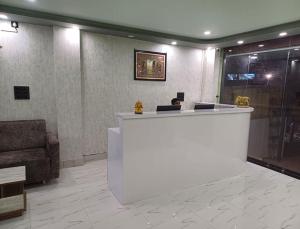 a lobby with a reception desk and a couch at Hotel Shobhani in Deoghar