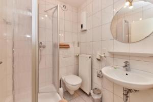 a bathroom with a shower and a toilet and a sink at Cafe Rosi Ferienwohnung in Bernkastel-Kues