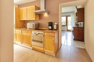 a kitchen with yellow cabinets and a stove at Cafe Rosi Ferienwohnung in Bernkastel-Kues +12 photos