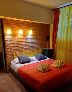 una camera con un letto con due cuscini sopra di Il Giardino del Viaggiatore a Roma