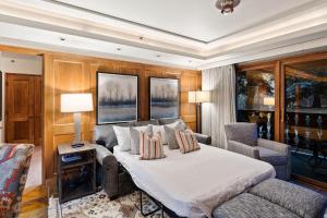 a bedroom with a bed and a couch at Bridge Street - Unit 202 in Vail