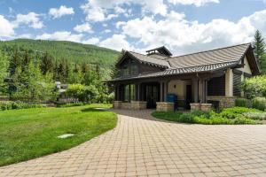 a house with a brick driveway in front of it at Bridge Street - Unit 202 in Vail