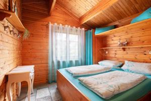 a bedroom with two beds in a wooden cabin at Hüssli Numero 1 in Hayingen +25 photos