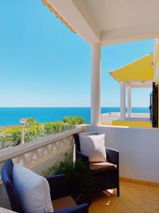 a balcony with chairs and a view of the ocean at Benagil Beach House - Victoria in Lagoa +14 photos