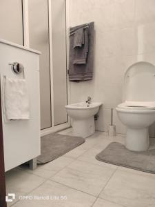 ein weißes Bad mit einem WC und einem Waschbecken in der Unterkunft casa sousa in Campanário