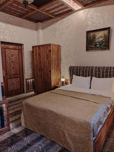 a bedroom with a large bed in a room at Qiz Galasi Hotel Baku in Baku