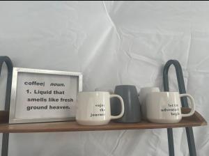 a shelf with coffee mugs and a box on it at Stargazer- The Dome Life in Anthem
