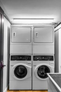 four washers and dryers stacked on top of each other in a kitchen at King Bed, The Phenix Historic Hotel, Spacious, Room # 406 in Bangor