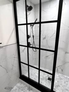 a shower with a glass door in a bathroom at King Bed, The Phenix Historic Hotel, Spacious, Room # 406 in Bangor