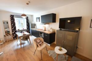 a living room with a kitchen and a dining room at Albarine-2 pers-wifi-cosy-confort-bien-être in Oyonnax