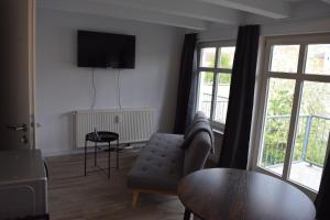 a living room with a couch and a table at Altstadt Kiek mal wedder in in Wismar