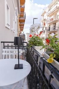 a lamp on a table on a balcony with flowers at Showroom Luxury B&B in Reggio Calabria +20 photos