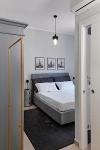 a bedroom with a large bed with white sheets at Showroom Luxury B&B in Reggio Calabria