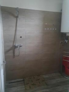 a bathroom with a shower with a toilet and a shower at Farkas Apartmanok in Balatonlelle