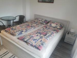 a bed in a room with two pillows on it at Farkas Apartmanok in Balatonlelle