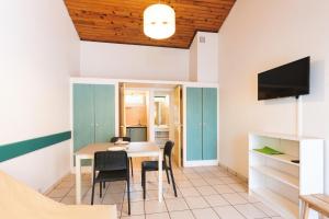 a kitchen and dining room with a table and chairs at Aux Portes des Monts d'Aubrac in Espalion