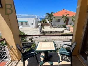 a patio with a table and chairs on a balcony at コテージマリンロード in Fukai +80 photos