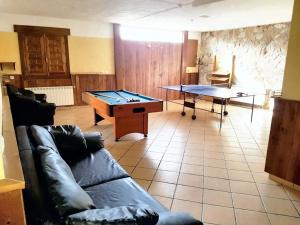 a living room with a couch and a ping pong table at 6 bedrooms villa with private pool enclosed garden and wifi at Velez Rubio in Vélez-Rubio