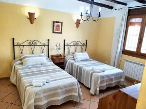 two beds in a room with white linens at 6 bedrooms villa with private pool enclosed garden and wifi at Velez Rubio in Vélez-Rubio