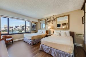 a hotel room with two beds and a large window at Outstanding Location - 1BR Haven near the Strip in Las Vegas