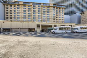 two vans parked in a parking lot in front of a building at Outstanding Location - 1BR Haven near the Strip in Las Vegas