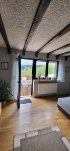 a living room with a couch and a large window at Haus Maria in NeuhÃ¼tten