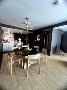 a dining room with a table and chairs at Seaport Apartments Pacifico H in Ushuaia