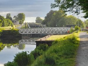 a bridge over a body of water with trees at Neptune's Rest in Fort William +7 photos