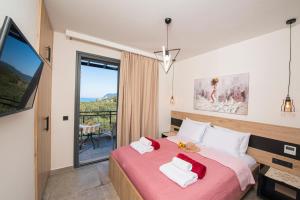 a bedroom with a large bed and a balcony at Villa Ilianthi in Kalamitsi