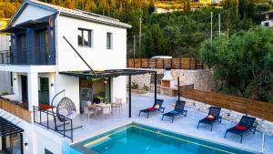 a villa with a swimming pool and a house at Villa Ilianthi in Kalamitsi