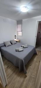 1 dormitorio con 1 cama con 2 toallas en Apartamento Maestra, en Jaén