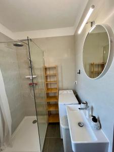 a bathroom with a shower and a sink and a mirror at Apartman Karmen in Trogir