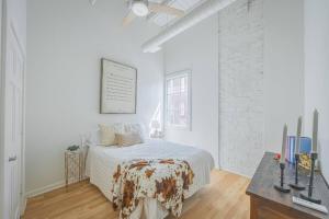 a white bedroom with a bed and a desk at Darlin' Downtown Dawghouse in Athens