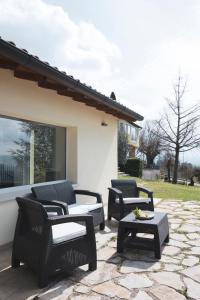a patio with four chairs and a table at La Meridiana Casa Vacanze in San Vitale
