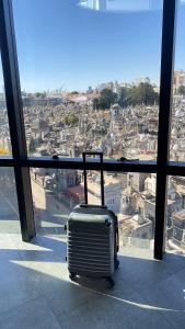 a suitcase is sitting in front of a window at MONS hostel in Buenos Aires