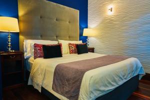 a bedroom with a large bed with pillows at Miravida Soho Hotel & Wine Bar in Buenos Aires