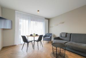 a living room with a couch and a table and chairs at Saga Studios by Heimaleiga in Reykjavík