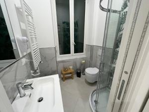 a bathroom with a sink and a shower and a toilet at Cherry rooms in La Spezia +25 photos