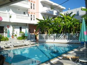 a swimming pool in front of a building at Elite Apartments in Kos