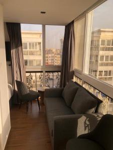 a living room with a couch and a large window at الحصرى Elhosary otel in 6th Of October