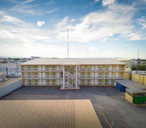a large building on top of a parking lot at Las Misiones Hotel in Monclova