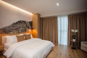 Postel nebo postele na pokoji v ubytování Oro Inn Hotel