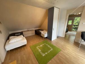 a small room with a bed and a green rug at 4 Guests: River & Garden Charm in Budapest