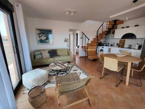 a living room with a couch and a table at Villa Moana Vistas al mar y Jacuzzi Lajares in Lajares