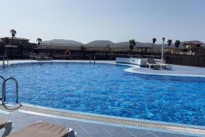 a large swimming pool with blue water at Villa Moana Vistas al mar y Jacuzzi Lajares in Lajares