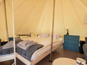 a bedroom with two beds in a tent at Glamping Szelągówka in Sorkwity